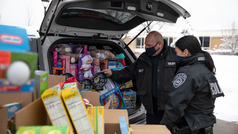 Police officers load cruiser with donated items